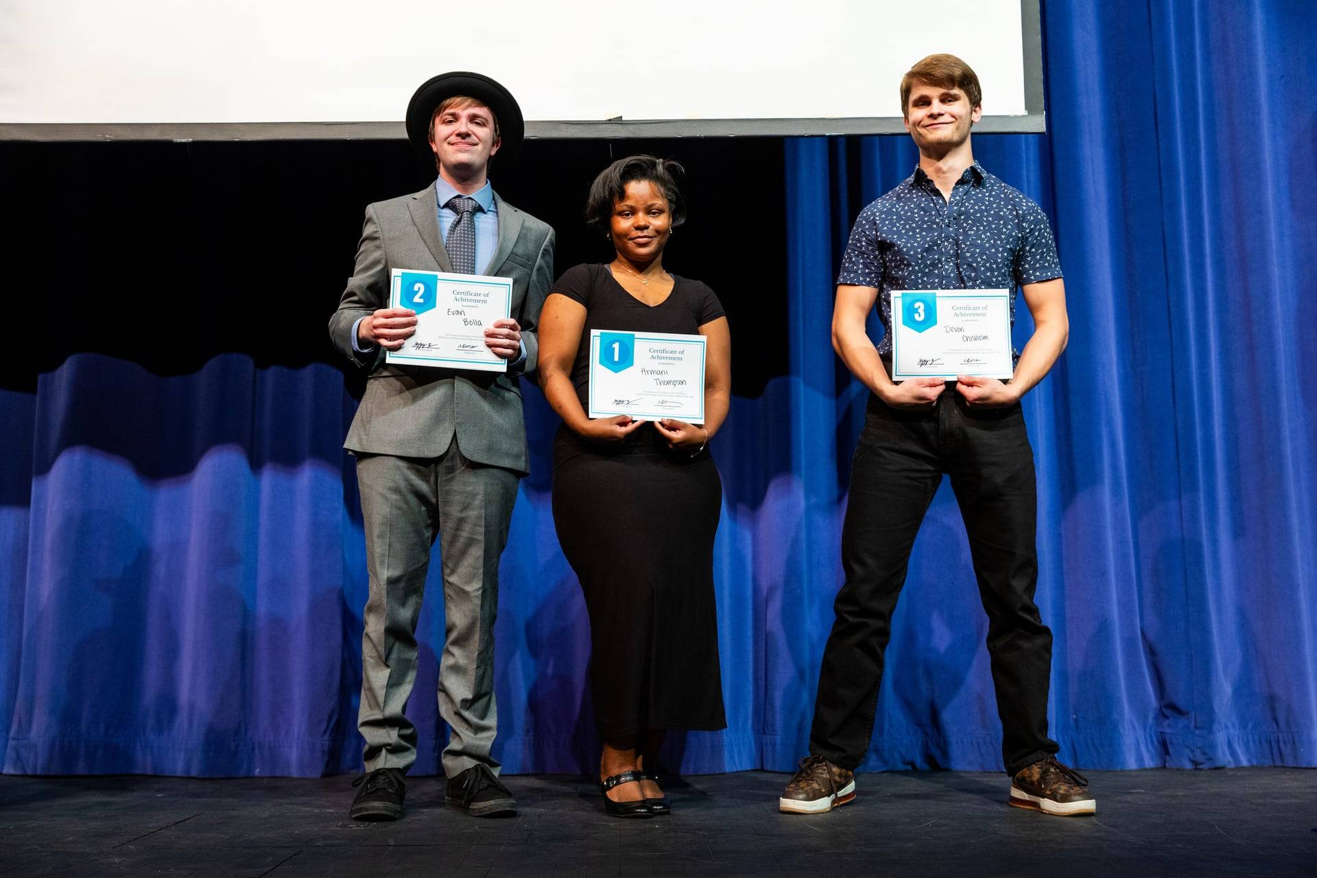 Student winners smiling at camera